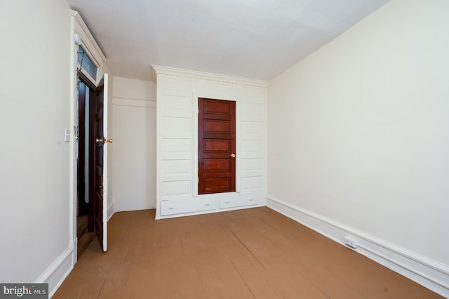 unfurnished bedroom with light wood-type flooring and a closet