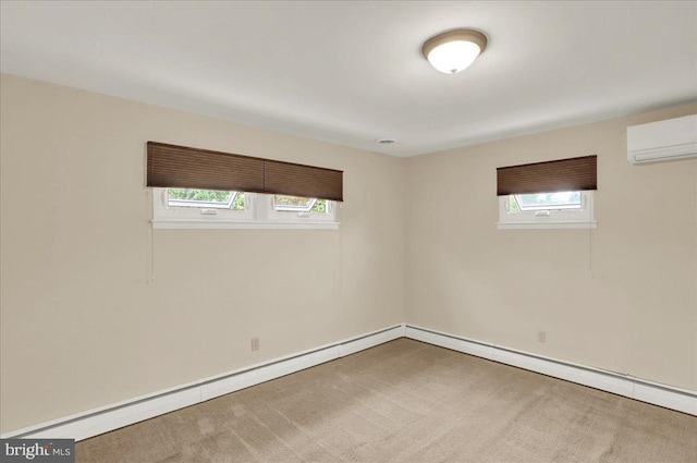 spare room with an AC wall unit, plenty of natural light, carpet flooring, and baseboards