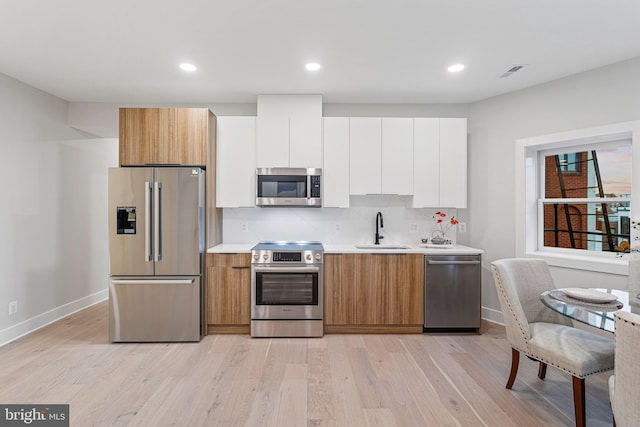 1724 Connecticut Ave NW Unit 8, Washington, DC 20009 - kitchen with stainless steel appliances, a sink, baseboards, light countertops, and recessed lighting