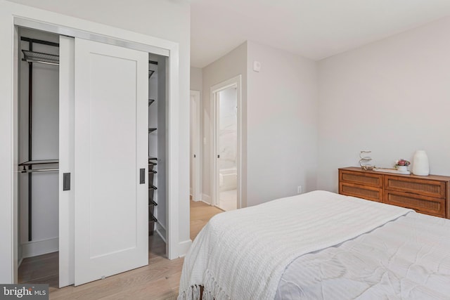 1724 Connecticut Ave NW Unit 8, Washington, DC 20009 - bedroom with light wood-type flooring, a closet, baseboards, and ensuite bathroom