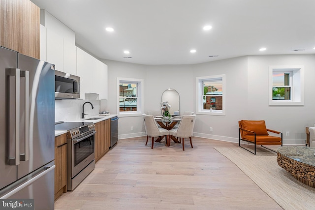 1724 Connecticut Ave NW Unit 8, Washington, DC 20009 - kitchen featuring stainless steel appliances, light wood finished floors, light countertops, recessed lighting, and modern cabinets