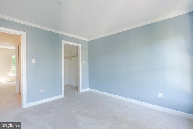 12221 Quadrille Ln, Bowie, MD 20720 - unfurnished bedroom featuring crown molding, baseboards, a walk in closet, light carpet, and a closet
