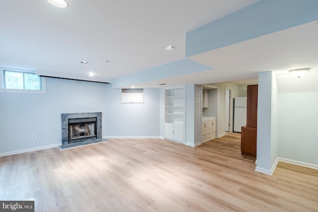 12221 Quadrille Ln, Bowie, MD 20720 - below grade area featuring freestanding refrigerator, a fireplace, light wood-style flooring, baseboards, and recessed lighting