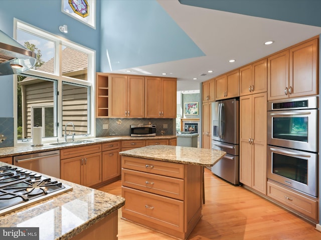 11583 Greenwich Point Rd, Reston, VA 20194 - kitchen with stainless steel appliances, a sink, open shelves, light wood-style flooring, and backsplash