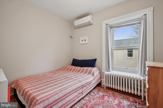 bedroom featuring radiator heating unit and a wall mounted air conditioner
