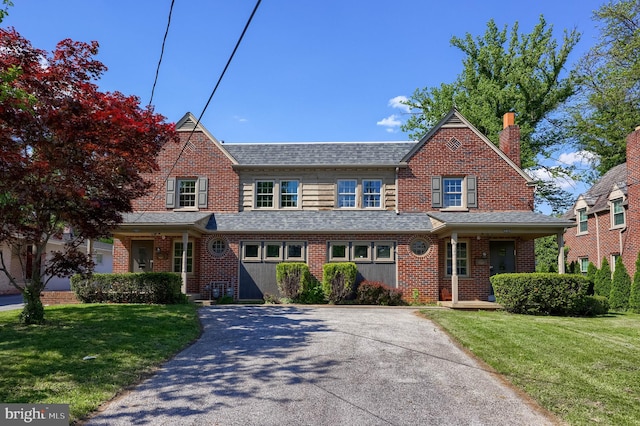 view of front of home with a front yard and brick siding