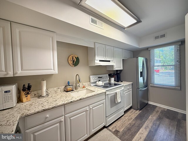 435 Lekites Ave Unit 435, Bethany Beach, DE 19930 - kitchen with white appliances, a sink, under cabinet range hood, dark wood-style floors, and white cabinets