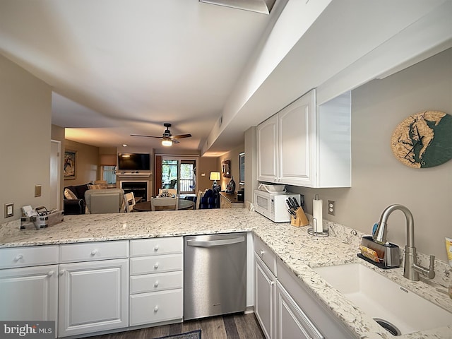 435 Lekites Ave Unit 435, Bethany Beach, DE 19930 - kitchen with stainless steel dishwasher, a ceiling fan, a sink, white microwave, and a fireplace