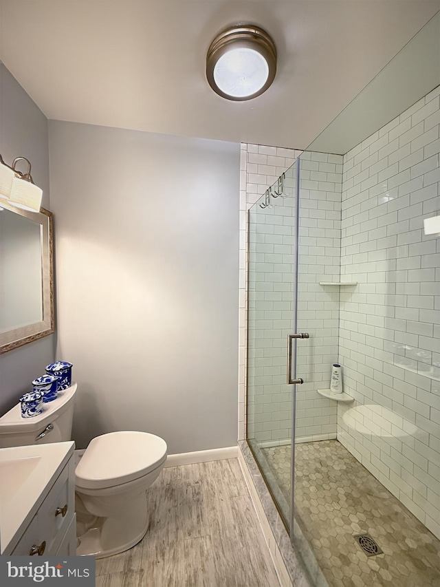 435 Lekites Ave Unit 435, Bethany Beach, DE 19930 - bathroom featuring toilet, a stall shower, vanity, and wood finished floors