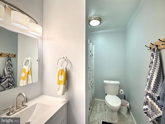 435 Lekites Ave Unit 435, Bethany Beach, DE 19930 - bathroom featuring wood finished floors, vanity, toilet, and baseboards