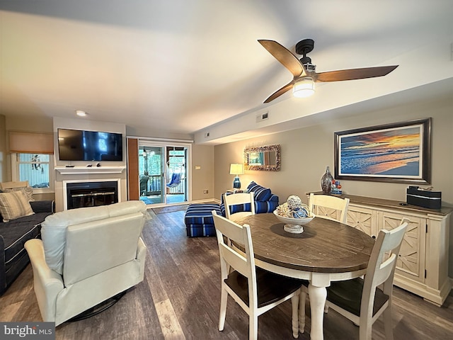 435 Lekites Ave Unit 435, Bethany Beach, DE 19930 - dining room featuring dark wood-type flooring, ceiling fan, and a glass covered fireplace