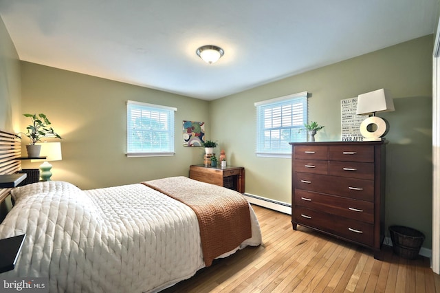 165 Wappler Dr, Hanover, PA 17331 - bedroom featuring multiple windows, a baseboard heating unit, and light wood-style flooring