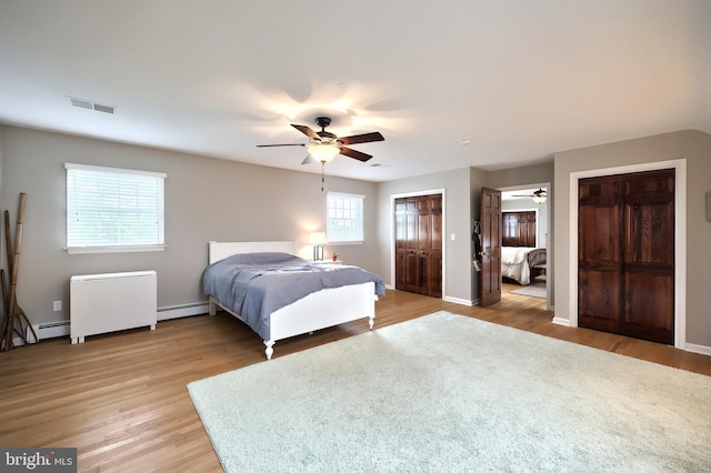 165 Wappler Dr, Hanover, PA 17331 - bedroom with two closets, light wood-style flooring, a baseboard heating unit, and ceiling fan
