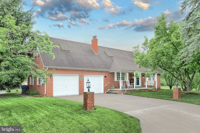 165 Wappler Dr, Hanover, PA 17331 - cape cod house with brick siding, a front yard, a garage, a porch, and concrete driveway