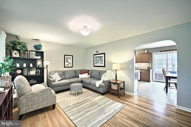 165 Wappler Dr, Hanover, PA 17331 - living room featuring arched walkways, light wood-style flooring, and baseboards