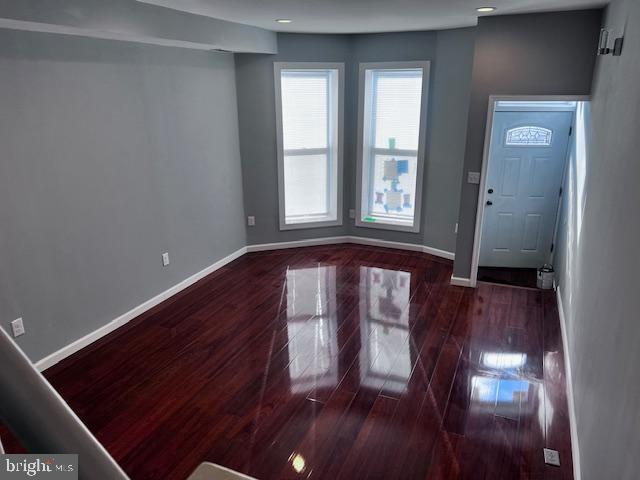 foyer featuring wood finished floors, baseboards, and recessed lighting