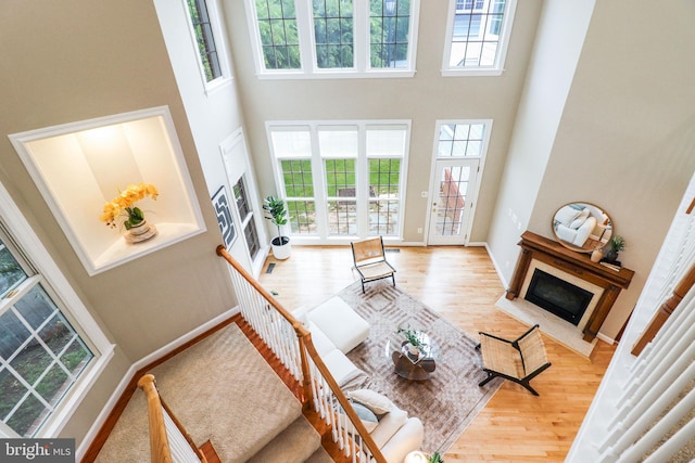 710 Crisfield Way, Annapolis, MD 21401 - living area with a high ceiling, plenty of natural light, wood finished floors, a fireplace with flush hearth, and baseboards
