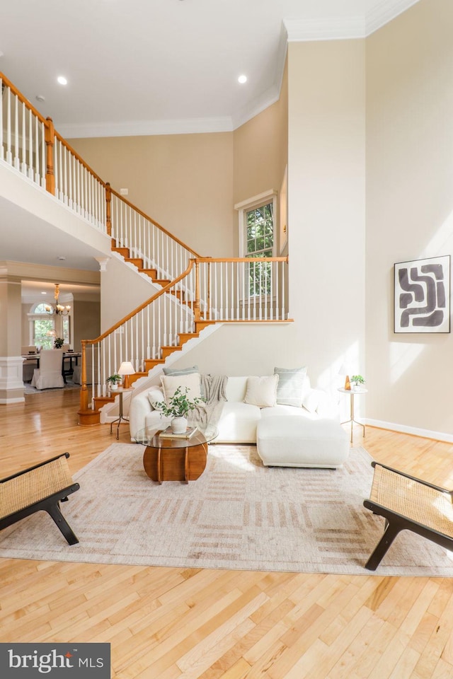 710 Crisfield Way, Annapolis, MD 21401 - living area with crown molding, a high ceiling, stairs, a chandelier, and wood finished floors