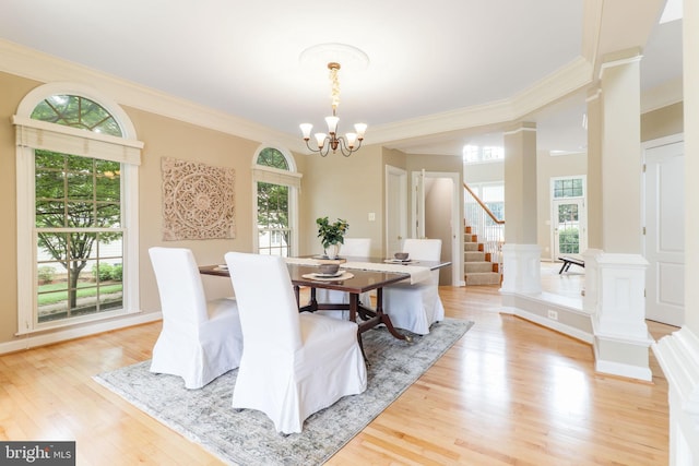 710 Crisfield Way, Annapolis, MD 21401 - dining room featuring stairway, a chandelier, ornamental molding, ornate columns, and light wood-type flooring