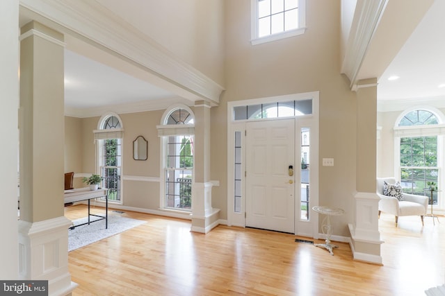 710 Crisfield Way, Annapolis, MD 21401 - entrance foyer with light wood-type flooring, decorative columns, ornamental molding, baseboards, and a towering ceiling