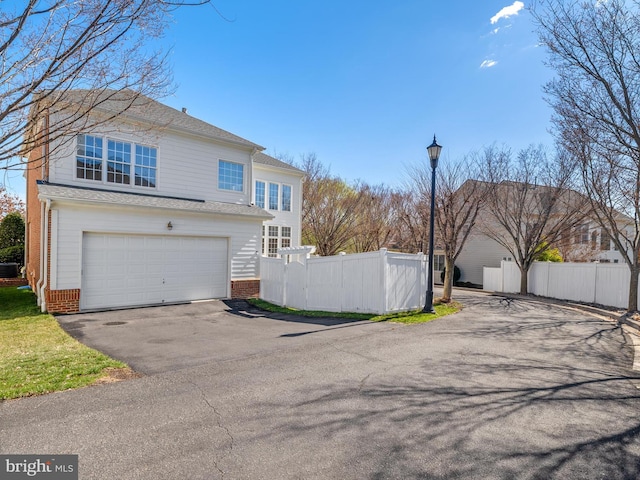 710 Crisfield Way, Annapolis, MD 21401 - view of property exterior featuring brick siding, asphalt driveway, fence, and an attached garage