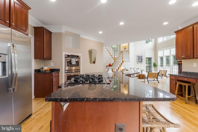 710 Crisfield Way, Annapolis, MD 21401 - kitchen with appliances with stainless steel finishes, a breakfast bar area, light wood-type flooring, crown molding, and recessed lighting