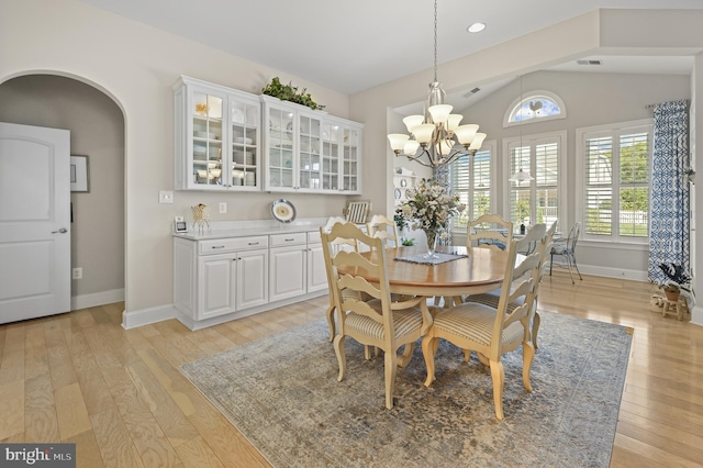 37546 Bella Via Way, Ocean View, DE 19970 - dining room with baseboards, light wood-style floors, arched walkways, and vaulted ceiling