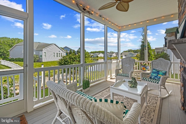 37546 Bella Via Way, Ocean View, DE 19970 - sunroom with rail lighting, ceiling fan, a water view, and a residential view