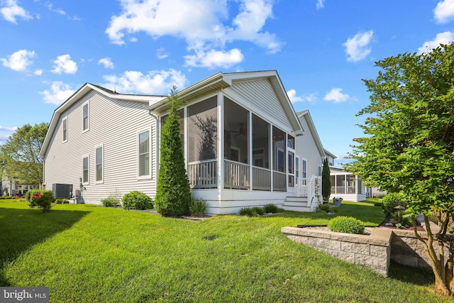 37546 Bella Via Way, Ocean View, DE 19970 - view of property exterior with a sunroom, a lawn, and central AC