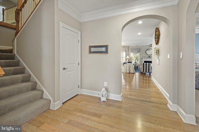 37546 Bella Via Way, Ocean View, DE 19970 - hallway with arched walkways, light wood-type flooring, baseboards, recessed lighting, and crown molding