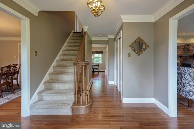 12 Meadow Woods Ln, West Grove, PA 19390 - foyer entrance with wood finished floors, stairway, crown molding, a chandelier, and baseboards