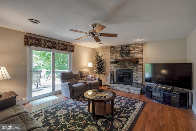12 Meadow Woods Ln, West Grove, PA 19390 - living room with wood finished floors, ceiling fan, a stone fireplace, and baseboards