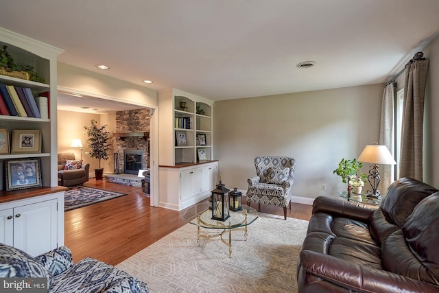 12 Meadow Woods Ln, West Grove, PA 19390 - living area featuring wood finished floors, a stone fireplace, baseboards, and recessed lighting