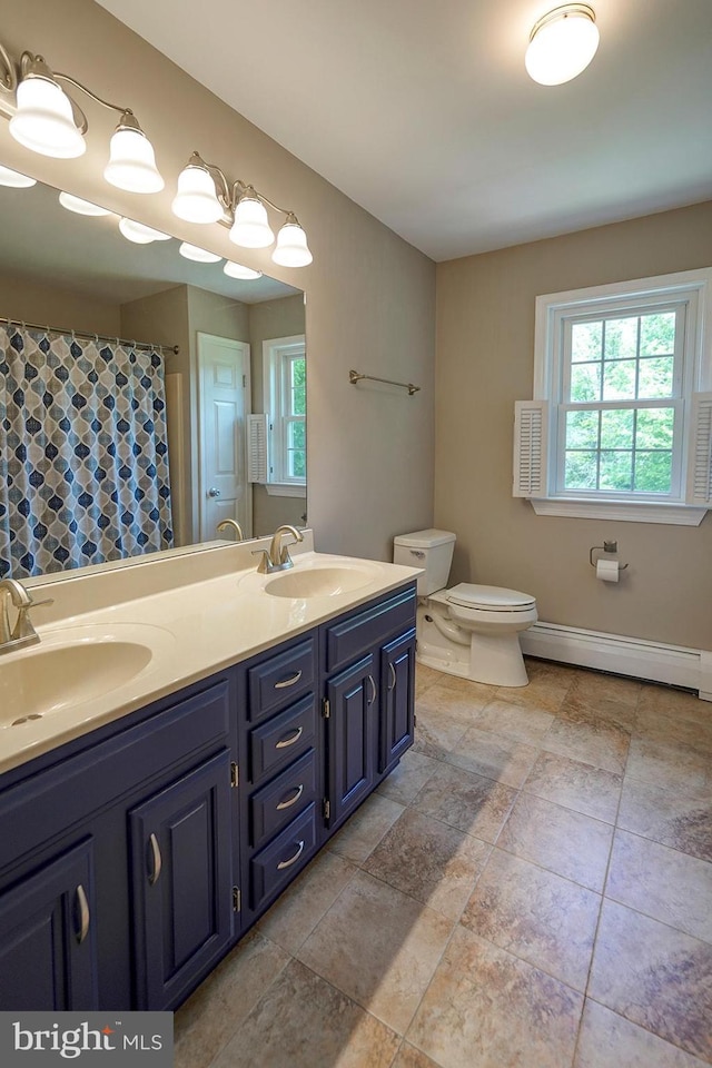 12 Meadow Woods Ln, West Grove, PA 19390 - full bath with a baseboard heating unit, toilet, double vanity, baseboards, and a shower with shower curtain