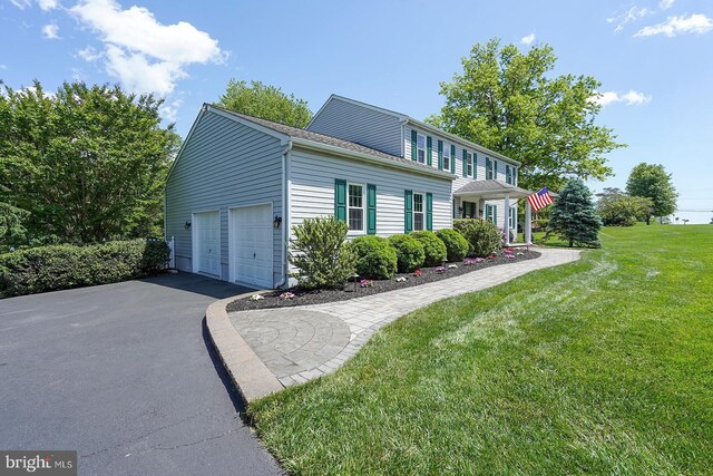 12 Meadow Woods Ln, West Grove, PA 19390 - view of front of property with driveway, a garage, and a front lawn