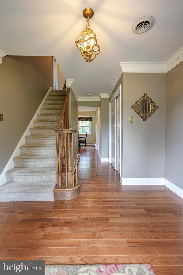 12 Meadow Woods Ln, West Grove, PA 19390 - stairs with crown molding, wood finished floors, baseboards, and a chandelier