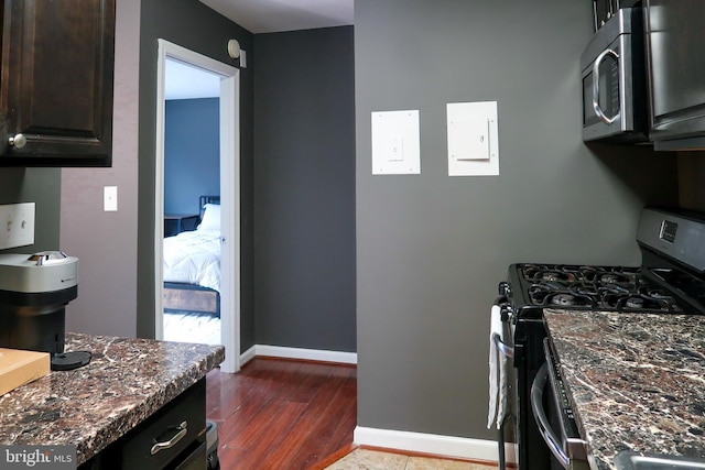 5538 Karen Elaine Unit 1625, Hyattsville, MD 20784 - kitchen featuring appliances with stainless steel finishes, wood finished floors, baseboards, dark stone counters, and dark brown cabinetry