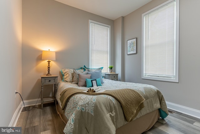 bedroom with wood finished floors and baseboards