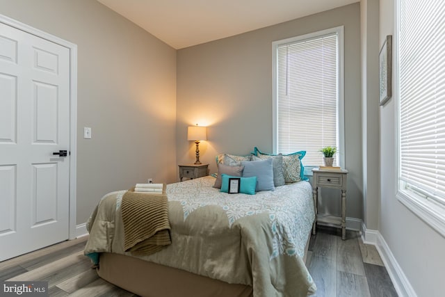 bedroom featuring wood finished floors and baseboards