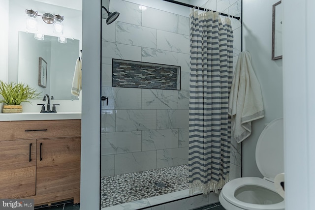 full bath with a shower stall, vanity, and toilet
