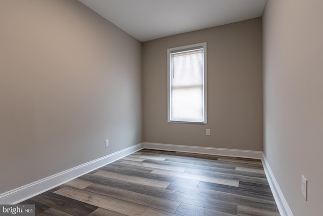 unfurnished room with wood finished floors and baseboards