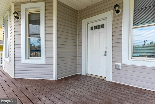 view of exterior entry with covered porch