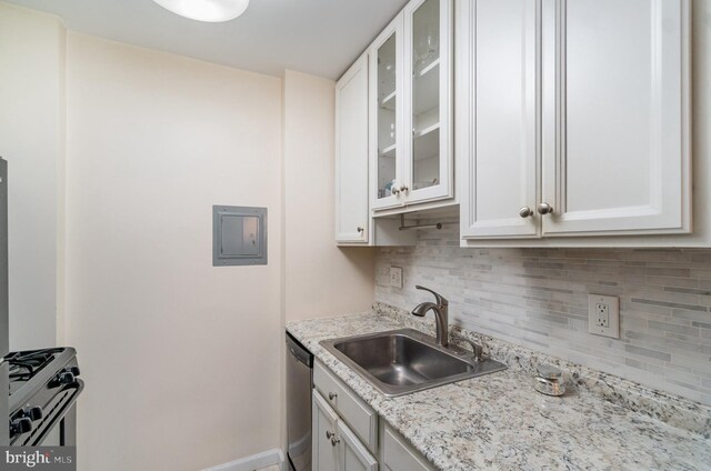 922 24th St NW Unit 419, Washington, DC 20037 - kitchen featuring decorative backsplash, electric panel, white cabinets, and gas stove