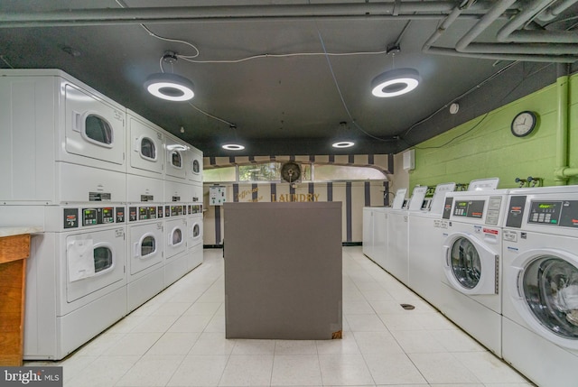 922 24th St NW Unit 419, Washington, DC 20037 - shared laundry with stacked washer / dryer, independent washer and dryer, light tile patterned flooring, and concrete block wall