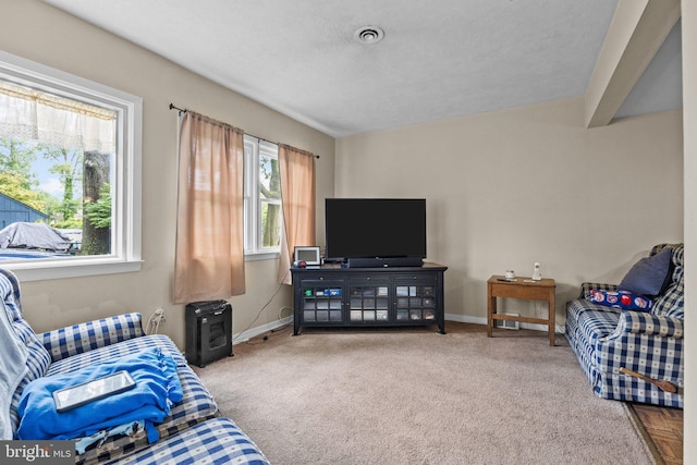 carpeted living area featuring baseboards