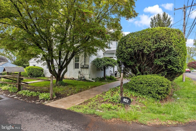 obstructed view of property featuring stucco siding and fence