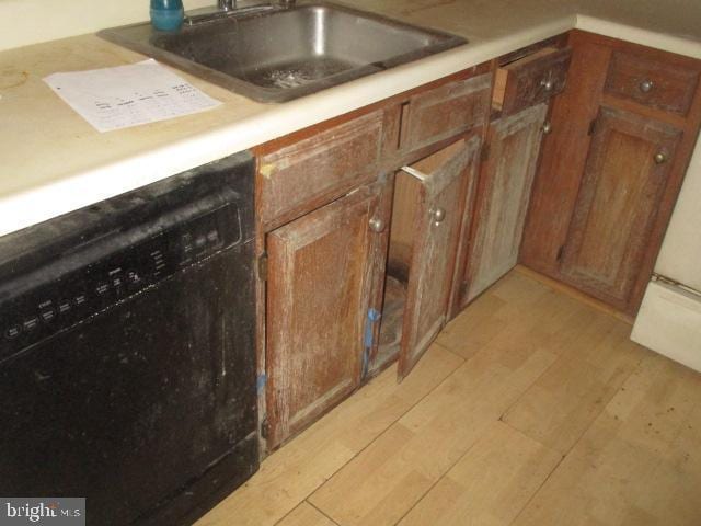 9410 Chippenham Dr, Laurel, MD 20723 - kitchen featuring black dishwasher, light wood-type flooring, brown cabinets, and light countertops
