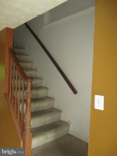 9410 Chippenham Dr, Laurel, MD 20723 - staircase featuring baseboards and a textured ceiling