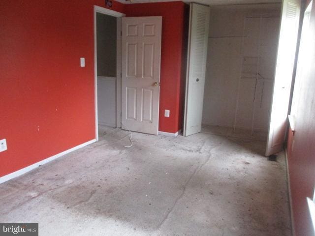 9410 Chippenham Dr, Laurel, MD 20723 - unfurnished bedroom with a closet and concrete flooring