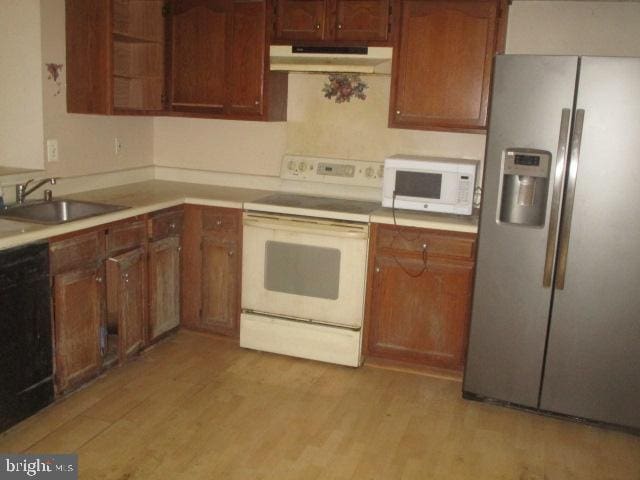 9410 Chippenham Dr, Laurel, MD 20723 - kitchen featuring white appliances, range hood, light countertops, and light wood-style floors